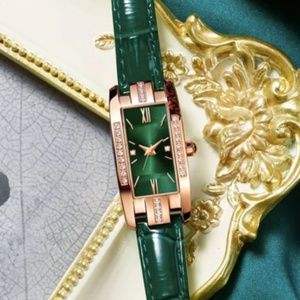 Elegant women's wrist watch with green shiny leather bracelet and golden frame